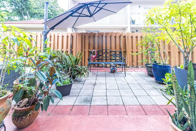 a view of a backyard with sitting area