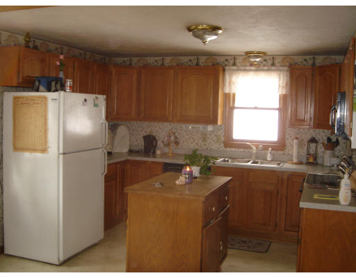 5 Proctor Road Pepperell, MA 01463 - Photo 3 of 12 a kitchen with refrigerator and window