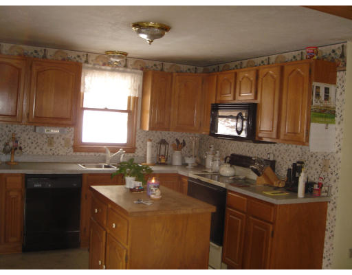 5 Proctor Road Pepperell, MA 01463 - Photo 4 of 12 a kitchen with a sink a window and cabinets