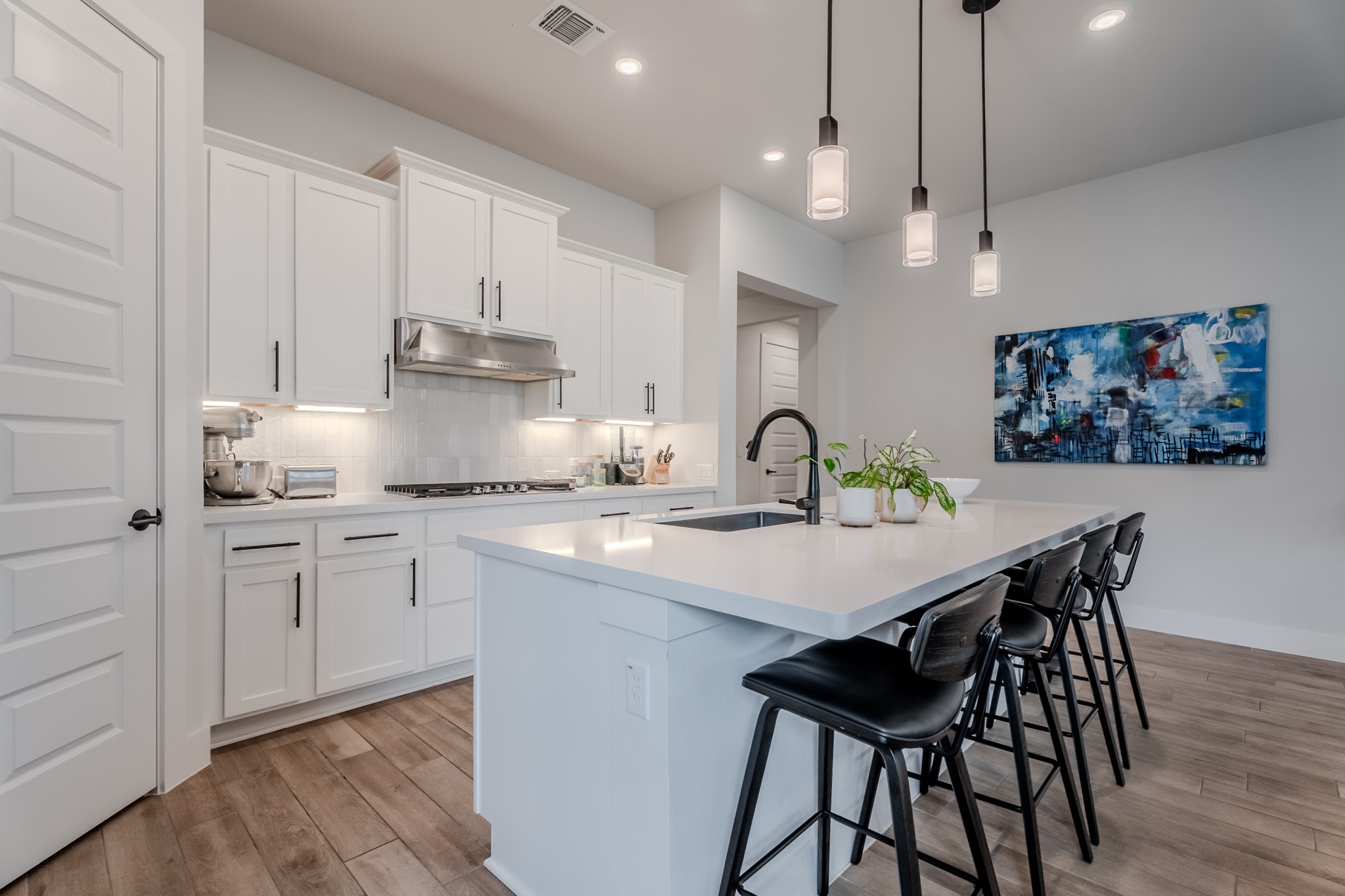 8109 Edmondson Bend Austin, TX 78744 - Photo 29 of 38 Culinary delights await in this bright kitchen with a spacious island, pendant lighting, and abundant cabinet storage.
