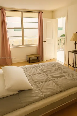 a bedroom with a bed and a window with outer view