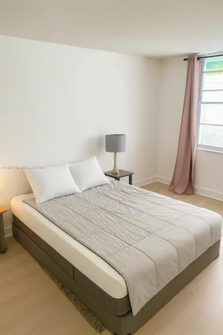 a bedroom with a bed and a night stand