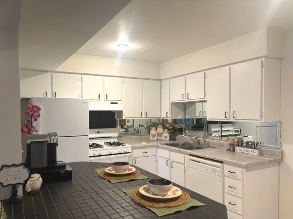a kitchen with a sink appliances and cabinets