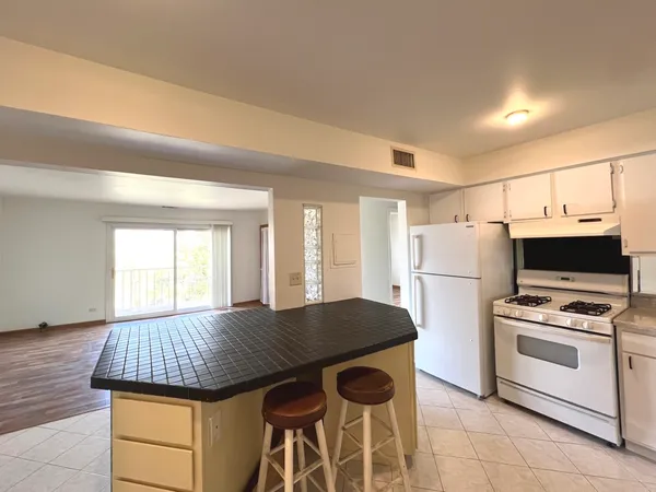 a kitchen with a stove a refrigerator and a stove top oven