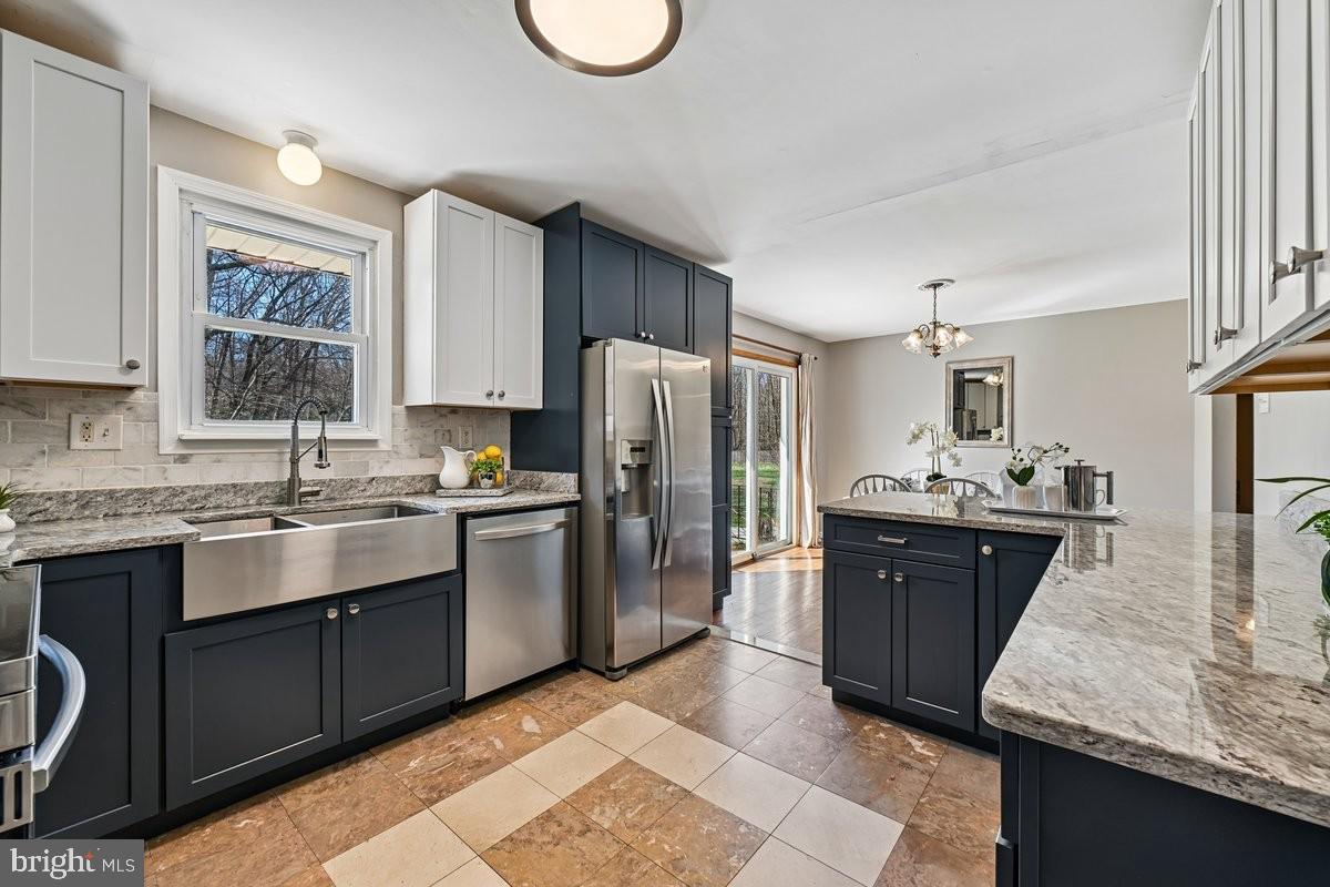 16601 Candy Hill Road Upper Marlboro, MD 20772 - Photo 14 of 55 a kitchen with stainless steel appliances granite countertop a sink stove refrigerator and cabinets