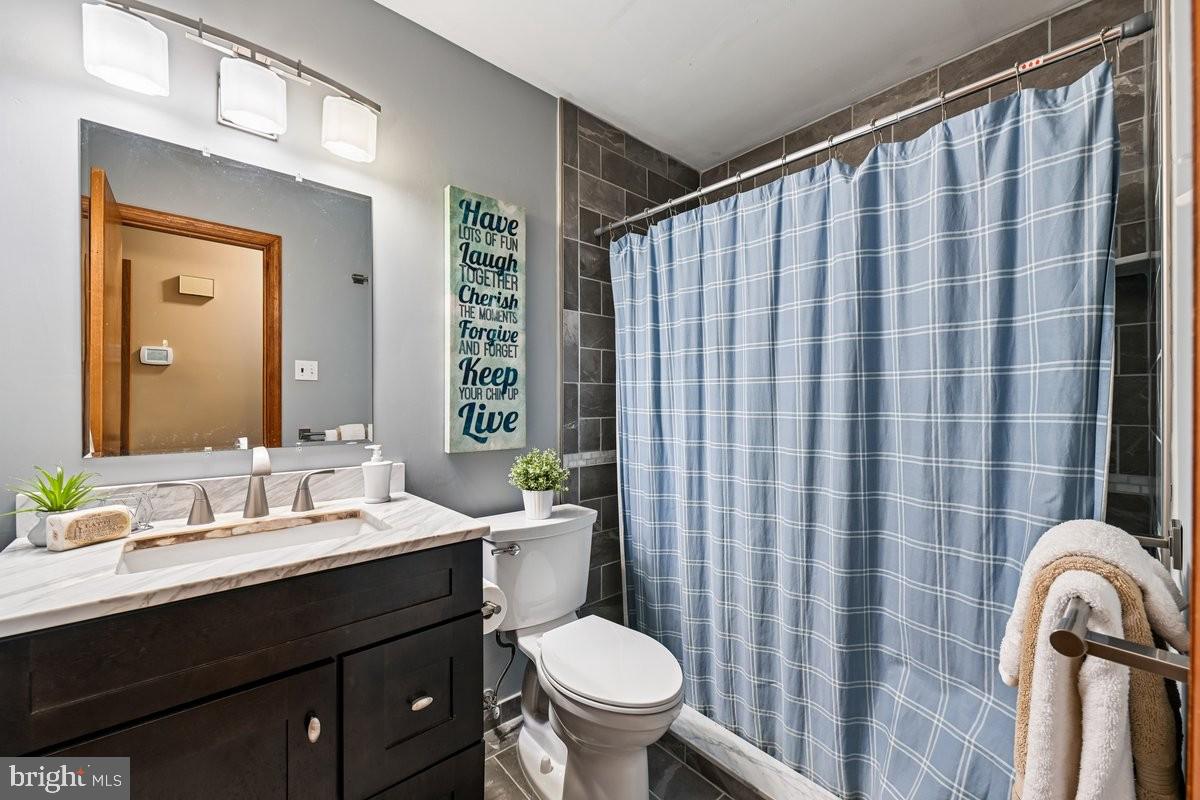 16601 Candy Hill Road Upper Marlboro, MD 20772 - Photo 19 of 55 a bathroom with a double vanity sink toilet and a mirror
