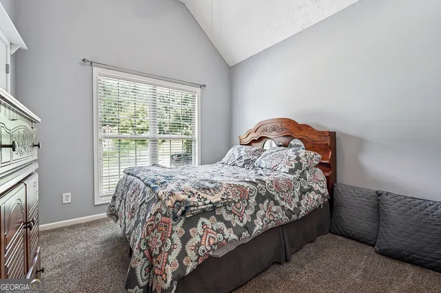 a bedroom with a bed next to a window with outer view