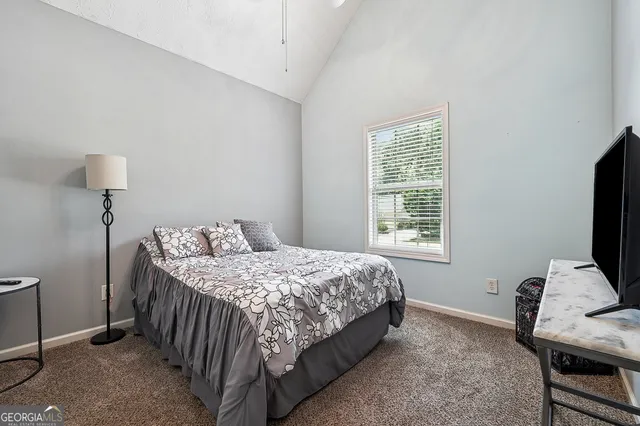 a bedroom with a bed and a desk