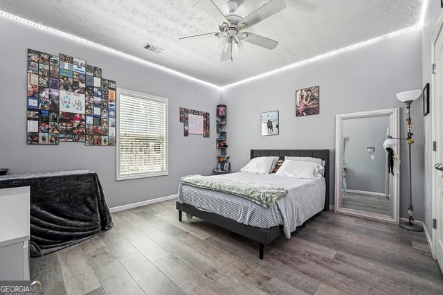 a spacious bedroom with a bed and a window