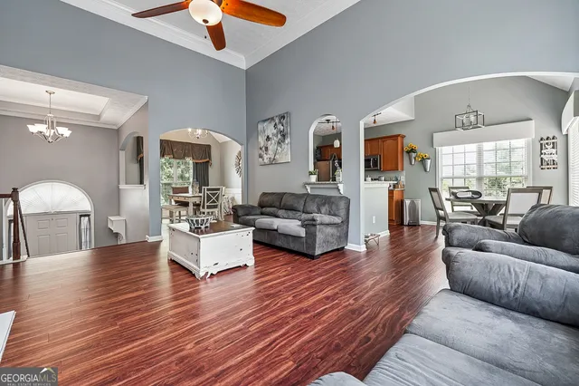 a living room with furniture and wooden floor
