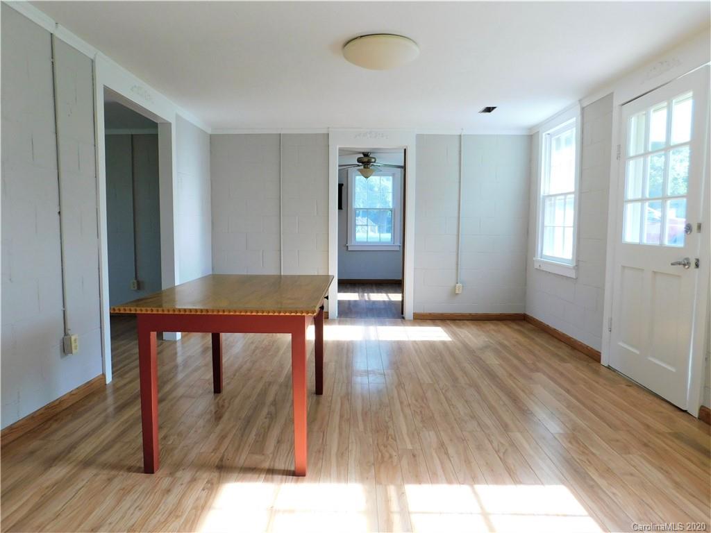 5411 Armfield Mill Road Monroe, NC 28112 - Photo 18 of 33 an empty room with wooden floor and windows