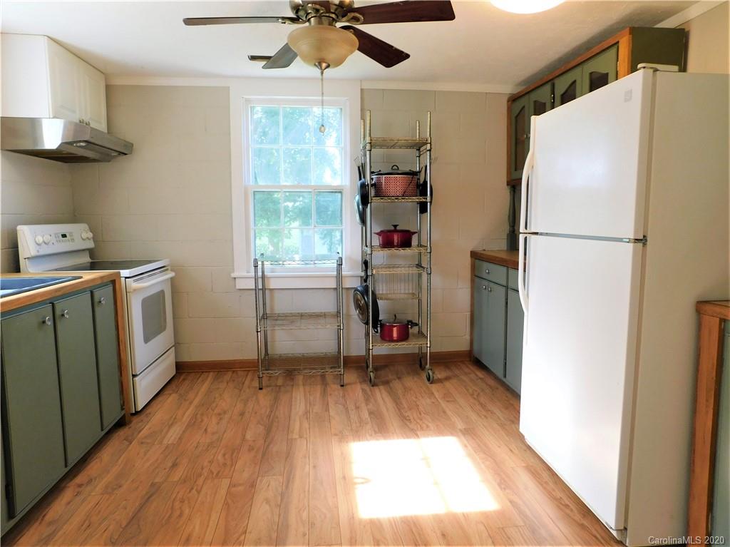 5411 Armfield Mill Road Monroe, NC 28112 - Photo 19 of 33 a view of a kitchen with a fridge wooden floor and a ceiling fan