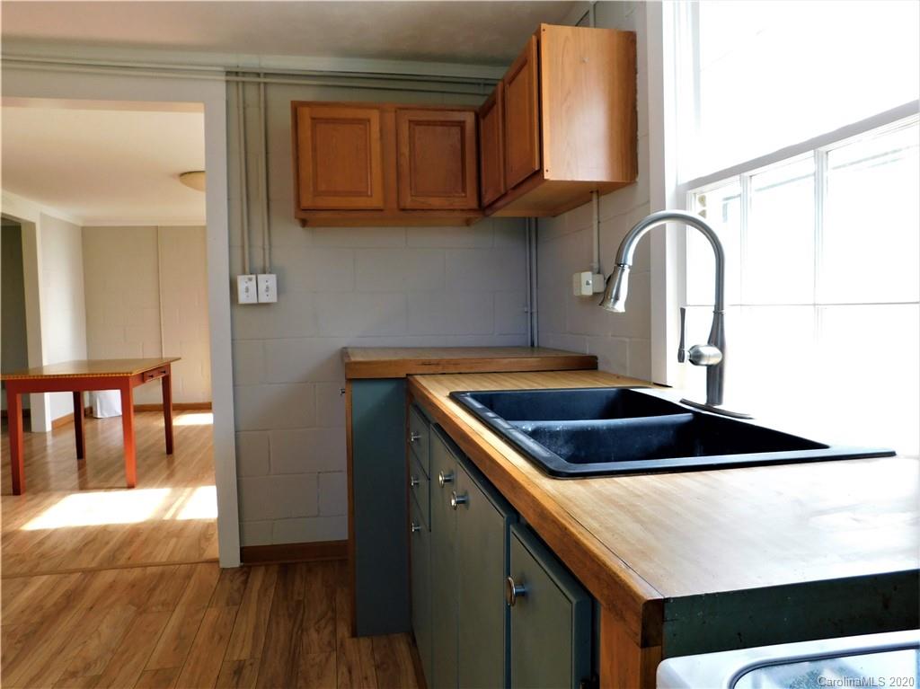 5411 Armfield Mill Road Monroe, NC 28112 - Photo 20 of 33 a kitchen with granite countertop a sink a stove and a wooden floor