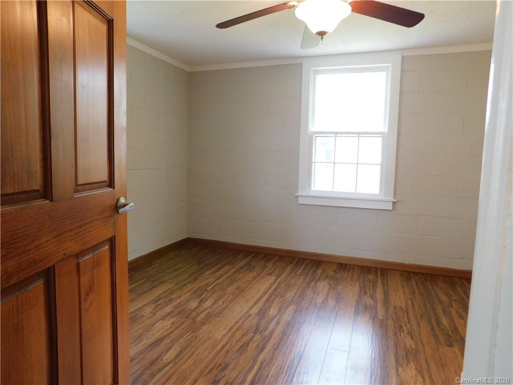 5411 Armfield Mill Road Monroe, NC 28112 - Photo 24 of 33 an empty room with wooden floor and windows