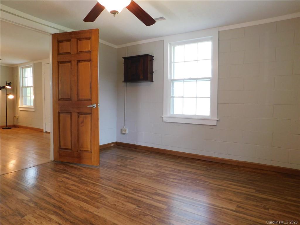 5411 Armfield Mill Road Monroe, NC 28112 - Photo 25 of 33 an empty room with wooden floor cabinet and windows