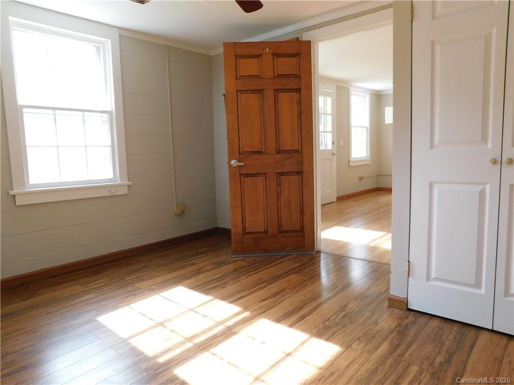 5411 Armfield Mill Road Monroe, NC 28112 - Photo 27 of 33 an empty room with wooden floor cabinet and windows