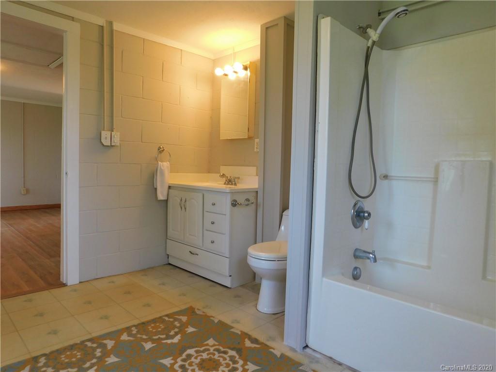 5411 Armfield Mill Road Monroe, NC 28112 - Photo 32 of 33 a bathroom with a granite countertop sink a toilet and shower