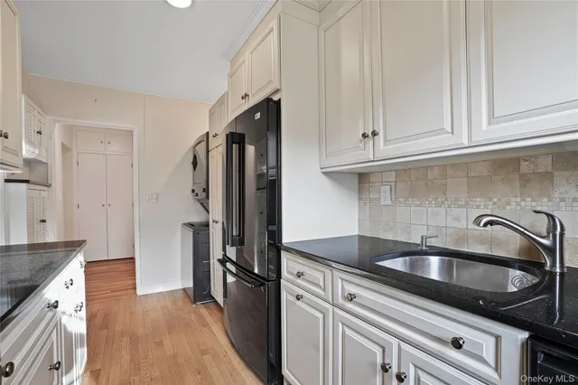 a kitchen with appliances a sink and cabinets