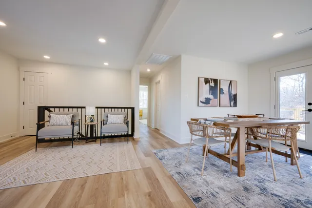 a living room with furniture a window and a table