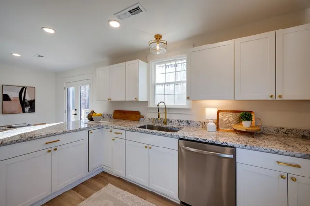 a kitchen with sink cabinets and window