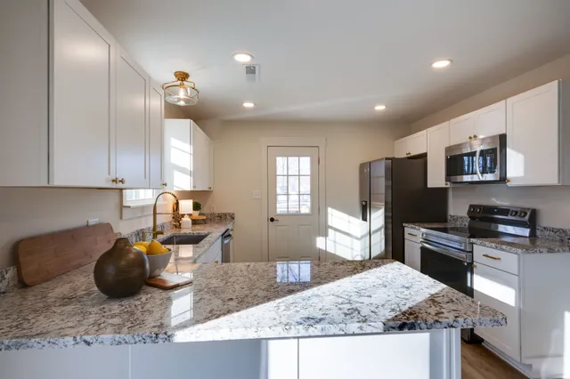 a kitchen with sink stove and refrigerator