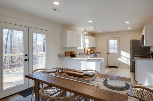 a kitchen with a table chairs stove and refrigerator