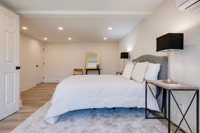 a bedroom with a bed and a flat screen tv