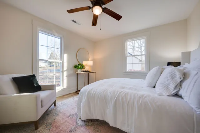 a bedroom with bed and a window