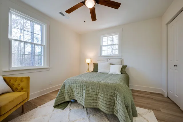 a bedroom with a bed a couch and window