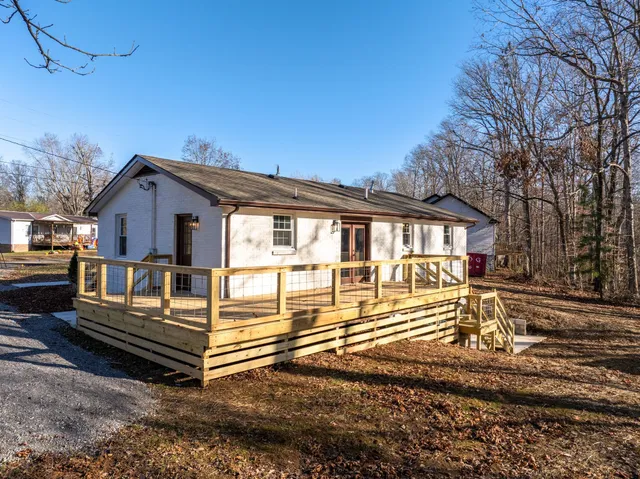 a view of a house with a wooden deck
