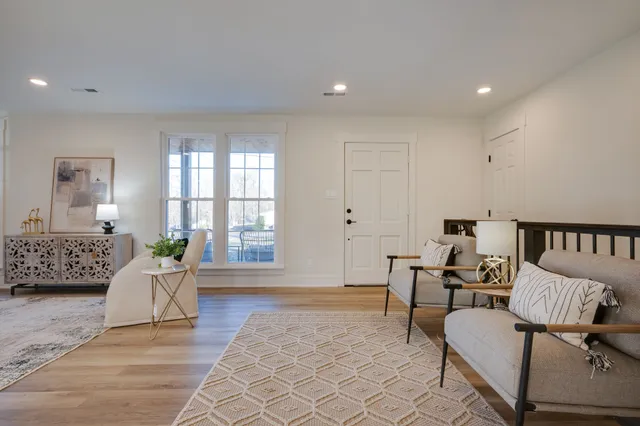a living room with furniture and wooden floor