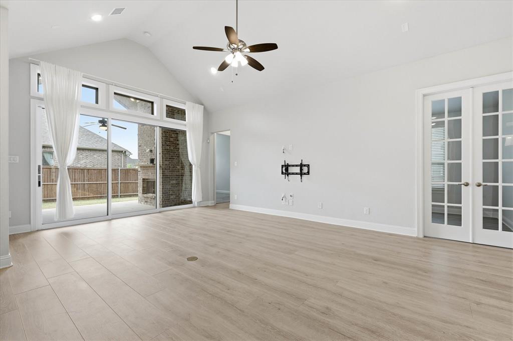 910 Cone Flower Drive Prosper, TX 75078 - Photo 13 of 40 a view of an empty room with a window and wooden floor