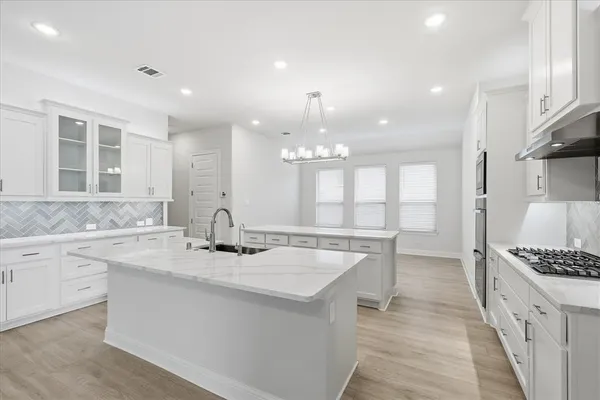 a kitchen with a sink stove and cabinets