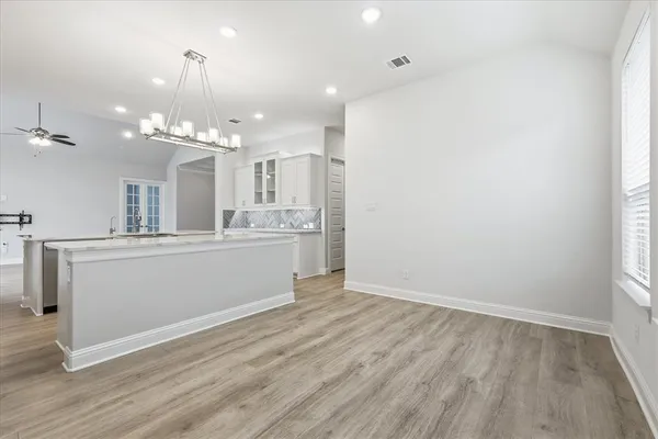 a view of a kitchen with a dishwasher and wooden floor