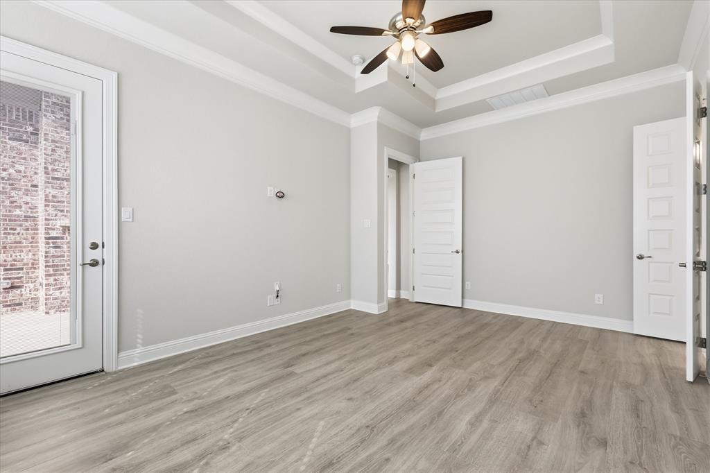 910 Cone Flower Drive Prosper, TX 75078 - Photo 21 of 40 a view of an empty room with wooden floor and a window