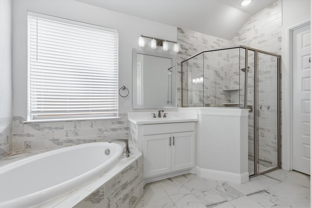 910 Cone Flower Drive Prosper, TX 75078 - Photo 23 of 40 a bathroom with a tub sink and mirror