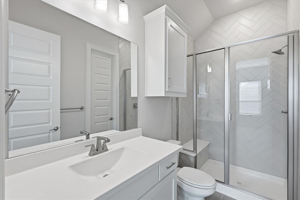 910 Cone Flower Drive Prosper, TX 75078 - Photo 27 of 40 a bathroom with a sink a toilet and shower