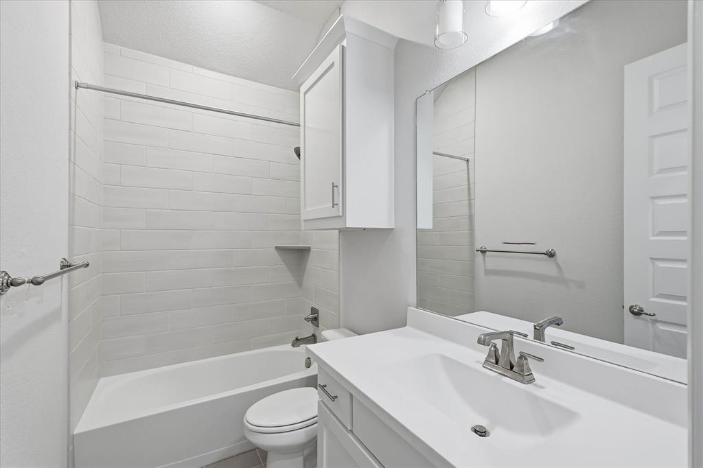 910 Cone Flower Drive Prosper, TX 75078 - Photo 29 of 40 a bathroom with a sink toilet and shower