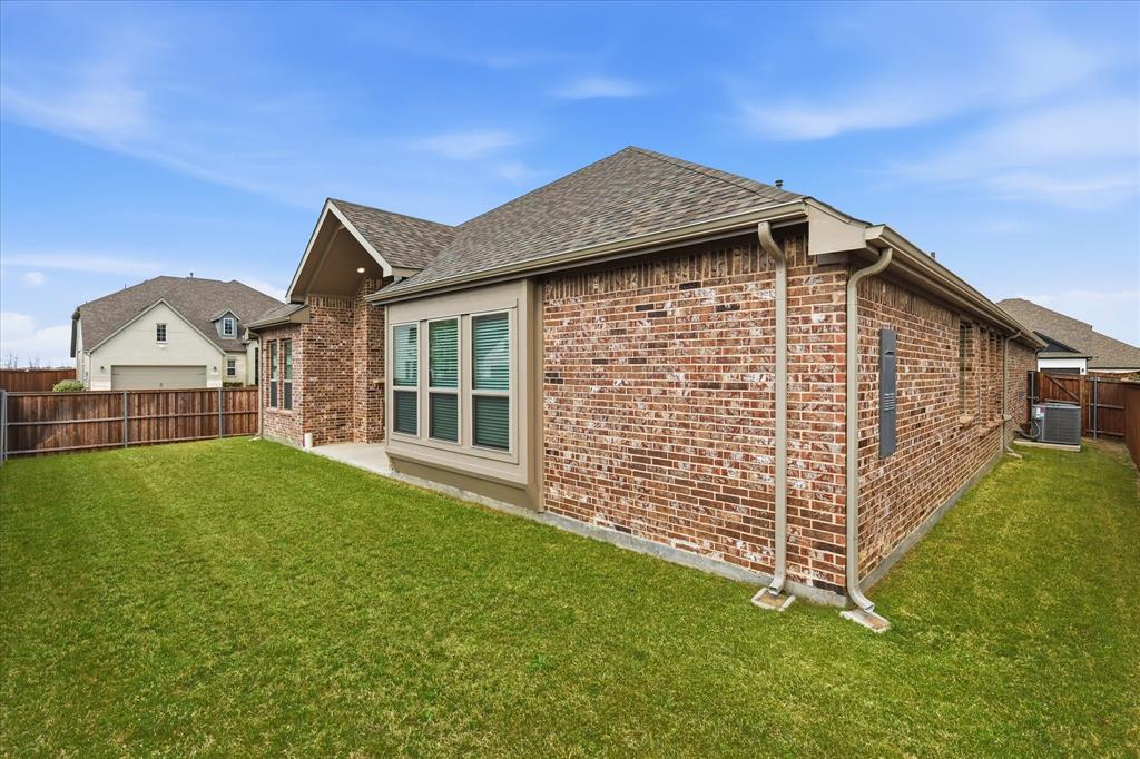 910 Cone Flower Drive Prosper, TX 75078 - Photo 36 of 40 a front view of a house with a garden