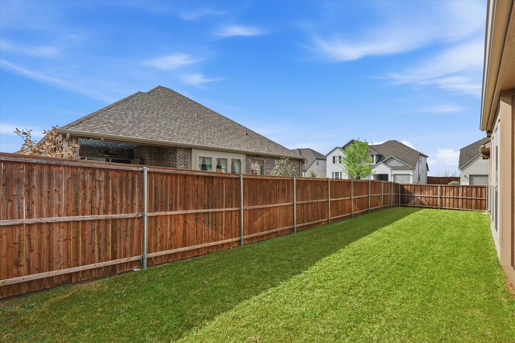 910 Cone Flower Drive Prosper, TX 75078 - Photo 37 of 40 a view of a garden with a wooden fence