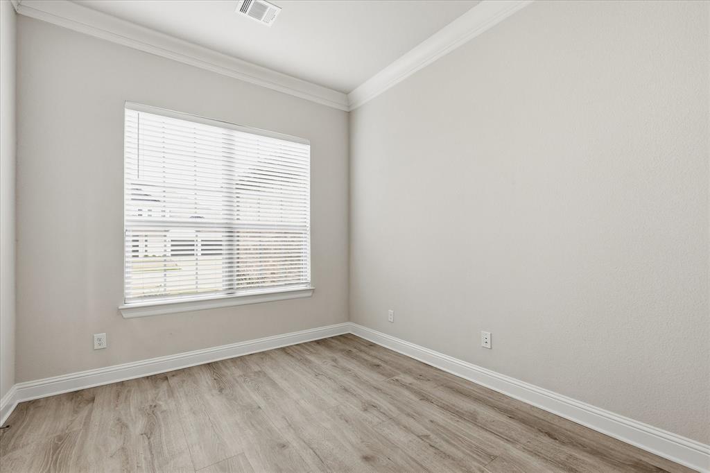 910 Cone Flower Drive Prosper, TX 75078 - Photo 4 of 40 an empty room with wooden floor and windows