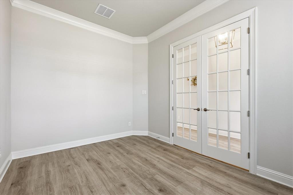 910 Cone Flower Drive Prosper, TX 75078 - Photo 5 of 40 an empty room with wooden floor closet and windows