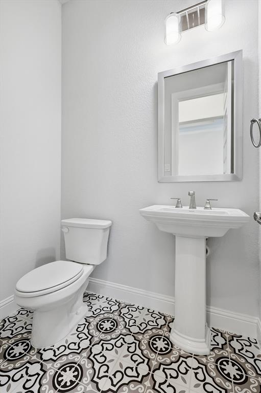 910 Cone Flower Drive Prosper, TX 75078 - Photo 6 of 40 a bathroom with a sink toilet and mirror