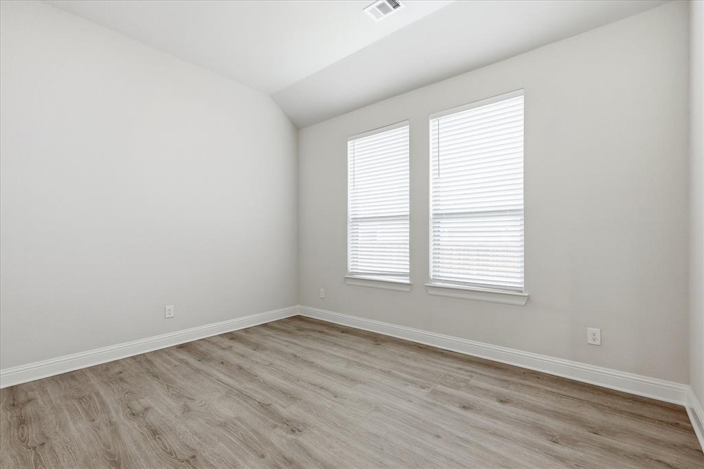 910 Cone Flower Drive Prosper, TX 75078 - Photo 7 of 40 an empty room with wooden floor and windows