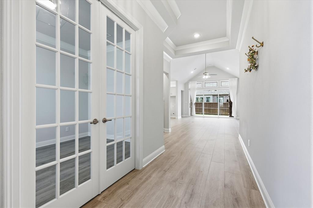 910 Cone Flower Drive Prosper, TX 75078 - Photo 9 of 40 a view of a hallway with wooden floor and windows