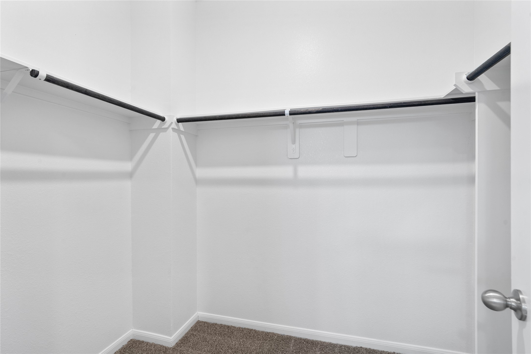 19555 Montgomery Rdg Way Montgomery, TX 77316 - Photo 29 of 38 The primary suite features a generous walk-in closet equipped with functional hanging rods and shelving.