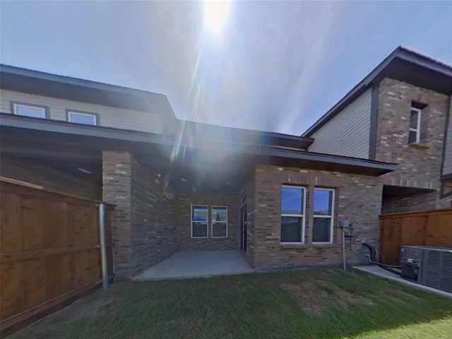 an aerial view of a house with a swimming pool patio and outdoor seating