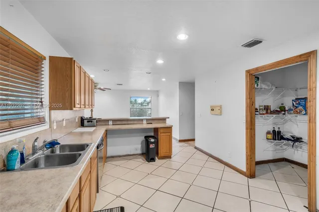 a kitchen with a sink a stove and cabinets