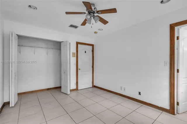 a view of a livingroom with a ceiling fan and window