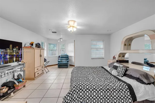 a bedroom with a bed furniture and a window